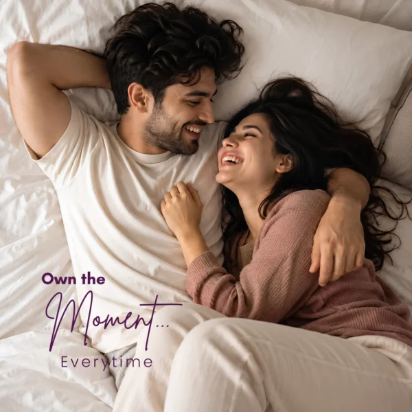 A happy couple lying in bed representing the intimacy and endurance benefits of using a daily stamina booster for men.